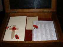 The ROH in a plain white cover. The cover was added to protect the book which has been restored. The same photograph shows the typed list of names transcribed from the ROH.