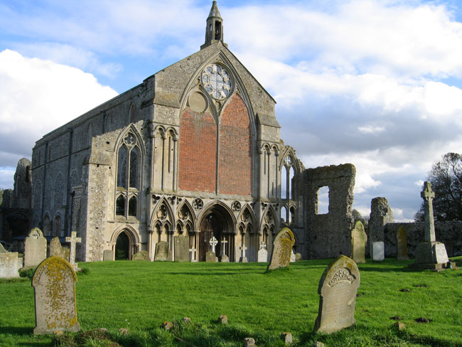 Binham War Memorial in the churchyard of the Priory Church of St Mary and the Holy Cross, on the right in this photo. 