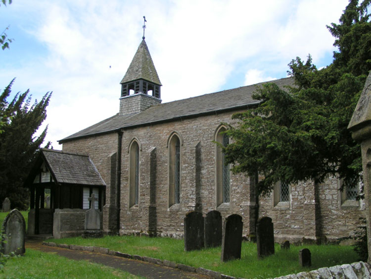 The Church of St. John the Evgangelist, Cowgill, showing the War Memorial outside the porch.