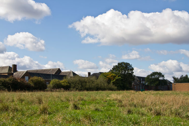 The rear of Grangefield Academy, seen from rough ground off Oxbridge Lane