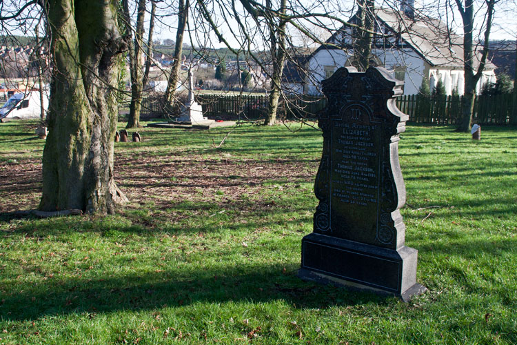 Private Jackson's grave in Eldon (St. Mark's) Churchyard, showing the Eldon War Memorial on the left