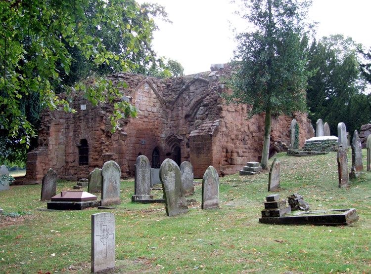A view of Alfred Kelsey's grave showing in the background the ruined Gatehouse
