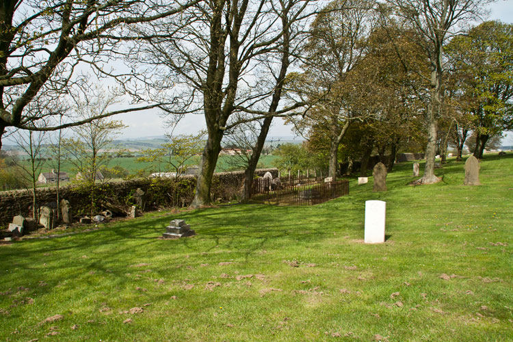 The section of Tow Law Cemetery in which Private Richardson's grave is located. His headstone can be seen in the background to the left of the tree. Note the headstones from graves which have been removed and are now standing against the wall.