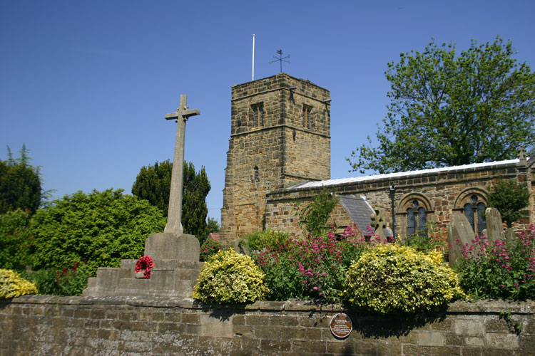 The War Memorial in front of the Church of St. Nicholas, Husthwaite.