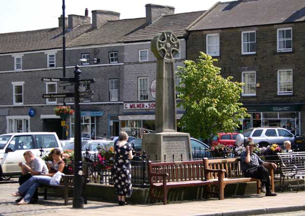 The War Memorial in the centre of Leyburn. The inscription records that the Memorial was erected near the site of the old Market Cross which was removed in 1837.