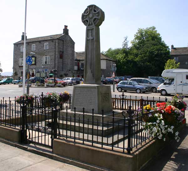 The War Memorial in the centre of Leyburn. The inscription records that the Memorial was erected near the site of the old Market Cross which was removed in 1837.