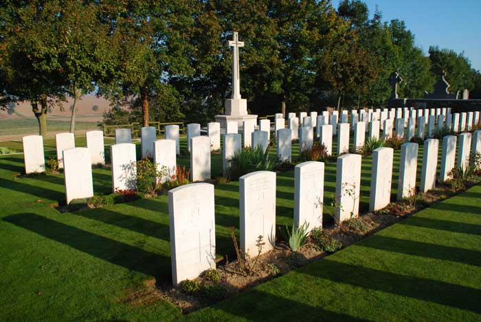 A view of the Heninel Communal Cemetery Extension, showing the Cross of Sacrifice.