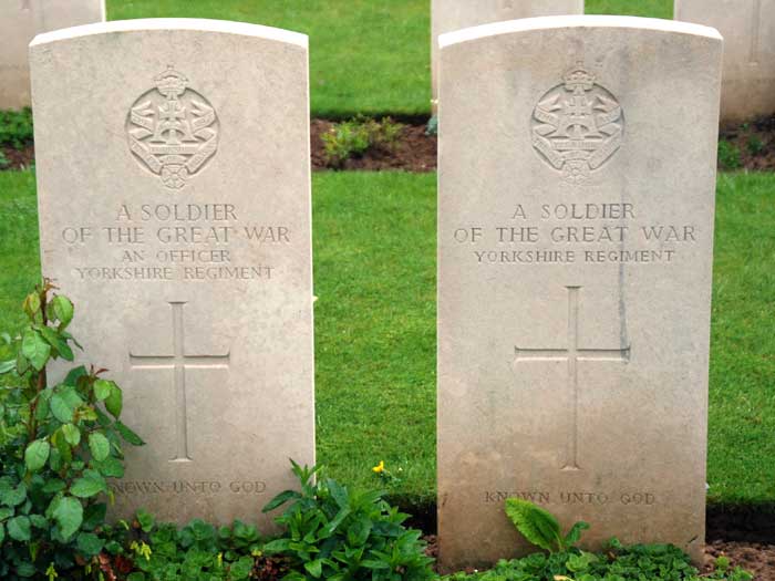 The graves of two unknown soldiers of the Yorkshire Tegiment, London British and Indian Cemetery. An officer is on the left, and a soldier on the right.