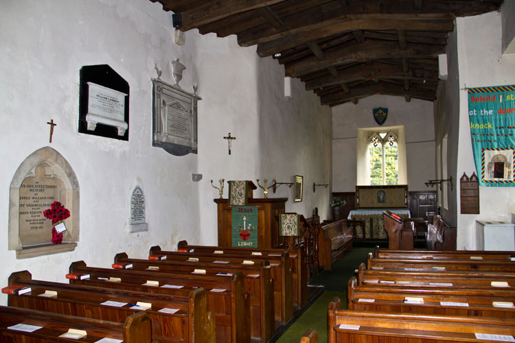 The Interior of St. Mary's Church, Redmire, showing the two War Memorials on the left.