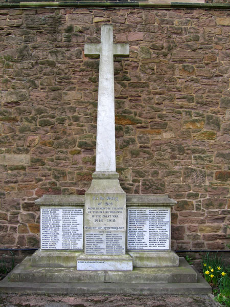 The War Memorial for Somercotes (Derbyshire) sited directly in front of the end wall of St . Thomas's Church