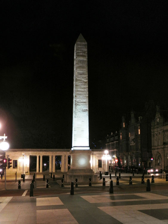 The Obelisk and Colonnades of the Southport War Memorial at night.