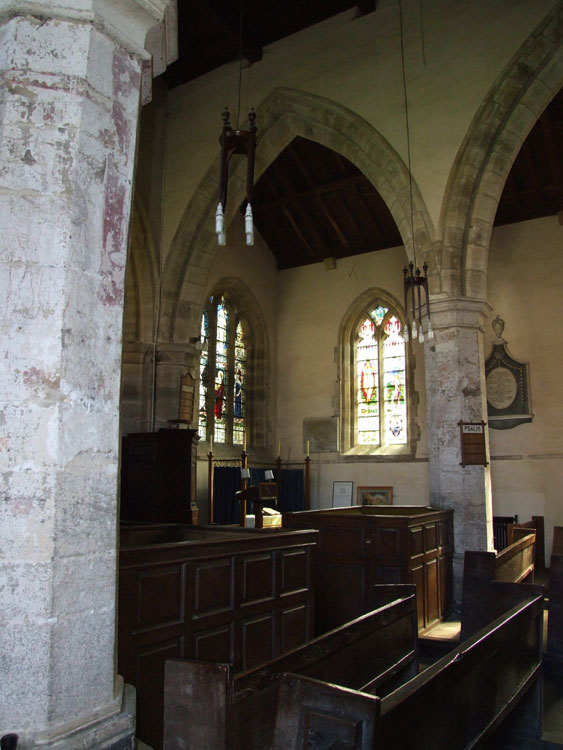 The interior of Holy Trinity Church, Wensley, with the Orde-Powlett Memorial Window directly ahead